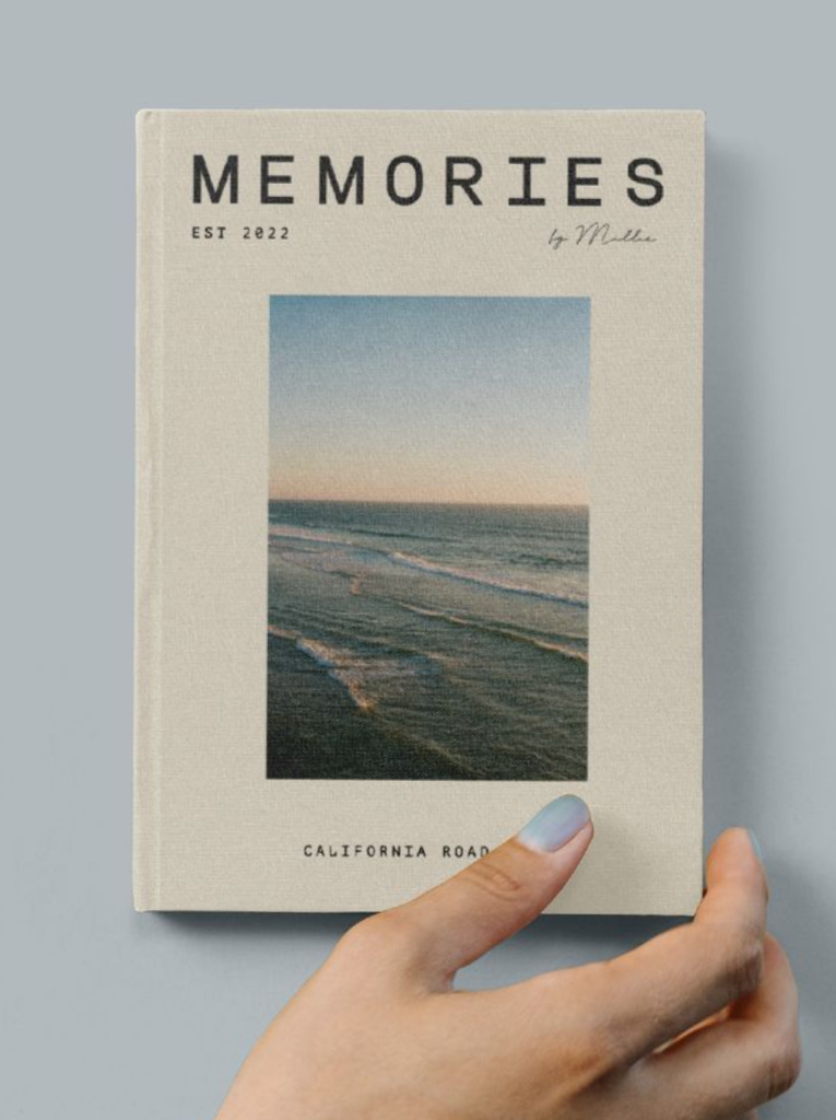 A printed memory book held in one hand